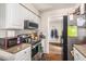 Bright kitchen showcasing stainless steel appliances and granite counters with adjacent laundry room at 7004 Lambright Ct, Tampa, FL 33634