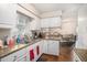 Charming kitchen featuring white cabinets, granite countertops, and an eat-in dining area at 7004 Lambright Ct, Tampa, FL 33634