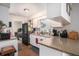 Efficient kitchen layout with granite countertops, a black refrigerator and wood-look flooring at 7004 Lambright Ct, Tampa, FL 33634