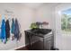 Modern laundry room with updated black washer and dryer set and access to the backyard at 7004 Lambright Ct, Tampa, FL 33634