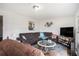 Spacious living area featuring a large sectional, a decorative coffee table, and ample natural light at 7004 Lambright Ct, Tampa, FL 33634