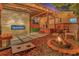 Outdoor living space with an electric fireplace, hot tub, and cozy fire pit at 7010 N Hubert Ave, Tampa, FL 33614