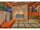 Outdoor living area with fireplace, bench, and pavers with artificial grass at 7010 N Hubert Ave, Tampa, FL 33614
