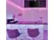 Finished basement bar featuring countertop, ambient lighting, and modern design elements at 7010 N Hubert Ave, Tampa, FL 33614