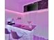 Basement bar featuring sleek countertop, ambient lighting, and comfortable seating at 7010 N Hubert Ave, Tampa, FL 33614