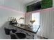 Charming bar area featuring stylish seating, granite countertop, and a large martini glass for entertaining at 7010 N Hubert Ave, Tampa, FL 33614