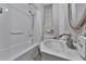 This is a full-size bathroom with a new sink, toilet and bathtub with shower at 7010 N Hubert Ave, Tampa, FL 33614