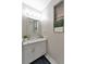 Well-lit bathroom features modern vanity with marble countertop, sleek faucet, and minimalist decorations at 7010 N Hubert Ave, Tampa, FL 33614