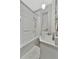 This is a well-lit bathroom with a new sink, toilet and bathtub with shower at 7010 N Hubert Ave, Tampa, FL 33614