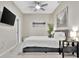 This bedroom has a queen-sized bed with black and white artwork. There is also a mounted TV at 7010 N Hubert Ave, Tampa, FL 33614