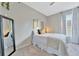 The bedroom has a new floor-length mirror, queen-sized bed and modern window at 7010 N Hubert Ave, Tampa, FL 33614