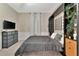 This bedroom features neutral walls and modern furniture to include a TV, dresser and mounted bed frame at 7010 N Hubert Ave, Tampa, FL 33614