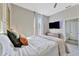 This bedroom has a queen-sized bed, a mounted TV, and a newly-carpeted floor at 7010 N Hubert Ave, Tampa, FL 33614