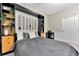 Stylized bedroom featuring a comfortable bed, built-in shelving, and a dedicated workspace with modern accents at 7010 N Hubert Ave, Tampa, FL 33614
