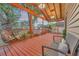 Relaxing front porch with stained wood deck, decorative lights and craftsman style trim at 7010 N Hubert Ave, Tampa, FL 33614