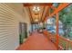 Wide front porch with wood floor, wood ceiling, and decorative accents at 7010 N Hubert Ave, Tampa, FL 33614