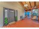 Charming front porch featuring a stained wood deck, hanging swing, and craftsman style accents at 7010 N Hubert Ave, Tampa, FL 33614
