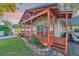 This house features a cozy front porch with wooden railings and decorative hanging chair at 7010 N Hubert Ave, Tampa, FL 33614