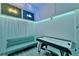 Inviting game room features an air hockey table and comfortable couch beneath neon signage and ambient lighting at 7010 N Hubert Ave, Tampa, FL 33614