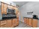 Kitchen with stainless steel microwave, wood cabinets, and a coffee bar at 7010 N Hubert Ave, Tampa, FL 33614
