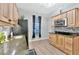 Bright kitchen features wood cabinets, stainless steel microwave, and granite countertops at 7010 N Hubert Ave, Tampa, FL 33614