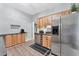 The kitchen features stainless steel appliances, wood cabinets, and a wine rack at 7010 N Hubert Ave, Tampa, FL 33614