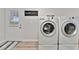 Laundry room featuring a modern washer and dryer on a light floor at 7010 N Hubert Ave, Tampa, FL 33614
