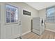 Well-lit laundry room with a washer and dryer set and access to the exterior at 7010 N Hubert Ave, Tampa, FL 33614