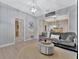 Living room with gray couch and a round ottoman at 7010 N Hubert Ave, Tampa, FL 33614