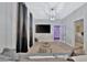 Modern living room featuring gray walls, decorative lighting, and an open doorway to the bedroom at 7010 N Hubert Ave, Tampa, FL 33614