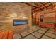 Outdoor patio with stone fireplace, hot tub, outdoor projector screen, and paver flooring at 7010 N Hubert Ave, Tampa, FL 33614