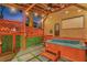 Back patio with hot tub, lattice fence, and outdoor movie screen at 7010 N Hubert Ave, Tampa, FL 33614