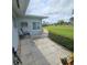 Back patio features a seating area and manicured landscaping at 7303 9Th W Ave # 7303, Bradenton, FL 34209