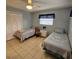 Guest bedroom includes tiled floors, ceiling fan, closet, and two twin beds at 7303 9Th W Ave # 7303, Bradenton, FL 34209