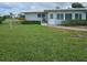 Single-story home with green grass and manicured landscaping at 7303 9Th W Ave # 7303, Bradenton, FL 34209