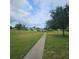 Landscaped grounds with lush green grass and walking paths throughout the community at 7303 9Th W Ave # 7303, Bradenton, FL 34209