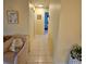 Inviting hallway leading to rooms, featuring neutral-toned walls, tile flooring, and bright overhead lighting at 7303 9Th W Ave # 7303, Bradenton, FL 34209