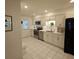 Well-lit kitchen featuring white cabinetry, stainless steel appliances, and a tiled backsplash at 7303 9Th W Ave # 7303, Bradenton, FL 34209