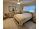 The main bedroom features a large mirror and tiled floors at 7303 9Th W Ave # 7303, Bradenton, FL 34209