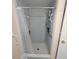 Shower features tiled walls, shower caddy, and grab bars at 7303 9Th W Ave # 7303, Bradenton, FL 34209
