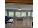 Bright and airy sunroom featuring tile floors, a ceiling fan, and views of the green outdoor space at 7303 9Th W Ave # 7303, Bradenton, FL 34209