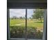 Scenic outdoor view from a window, showcasing a lush green lawn and clear blue sky at 7303 9Th W Ave # 7303, Bradenton, FL 34209
