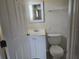 Clean bathroom featuring a white vanity, toilet, and a mirror with a white frame at 7307 50Th N Ave, St Petersburg, FL 33709