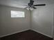 This bedroom has a ceiling fan and a window to provide light at 7307 50Th N Ave, St Petersburg, FL 33709