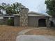 Charming single-story home with a stone chimney and an arched entryway at 7307 50Th N Ave, St Petersburg, FL 33709
