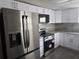 Bright kitchen with stainless steel appliances and white cabinets at 7307 50Th N Ave, St Petersburg, FL 33709