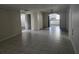 Open-concept living room with tiled floor leading into the kitchen at 7307 50Th N Ave, St Petersburg, FL 33709
