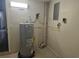 Utility room with a water heater, electrical panel, and tiled floor at 7307 50Th N Ave, St Petersburg, FL 33709