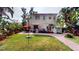 Spacious backyard with lush lawn, patio area featuring outdoor seating and barbecue grill at 75 Adalia Ave, Tampa, FL 33606