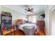 Inviting bedroom with a ceiling fan, hardwood floors, and a mounted TV at 75 Adalia Ave, Tampa, FL 33606